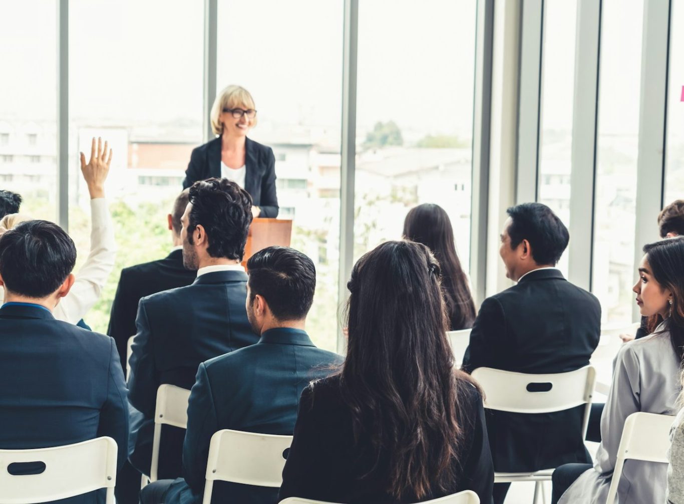 Lecturer presenting to professionals seated in a bright training room